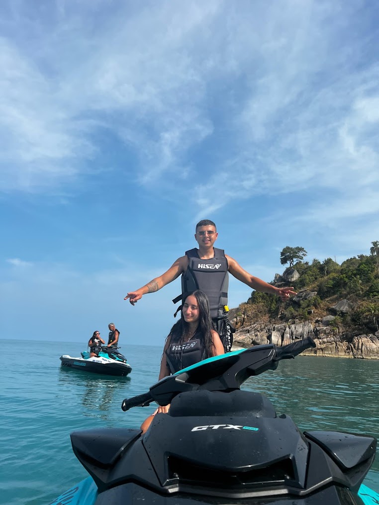 Couple standing beside a Sea-Doo GTX jet ski on a Koh Samui beach