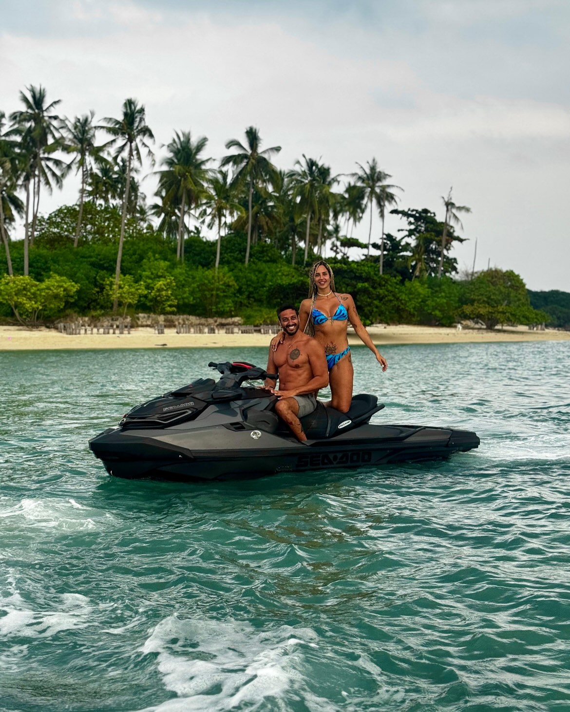 Couple on a black Sea-Doo jet ski with a Koh Samui island in the background