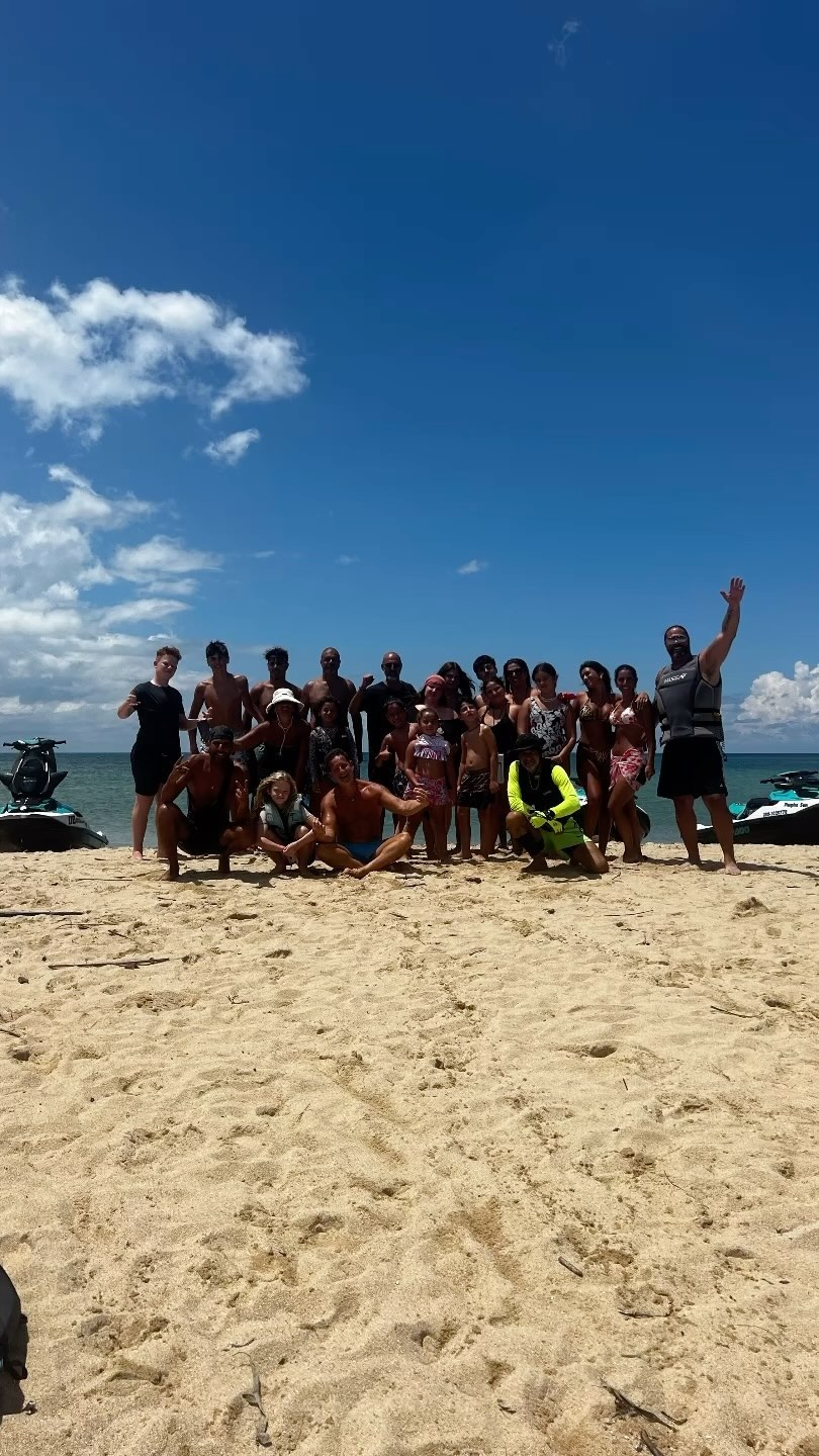 Group of riders posing on the sand next to Sea-Doo jet skis in Koh Samui